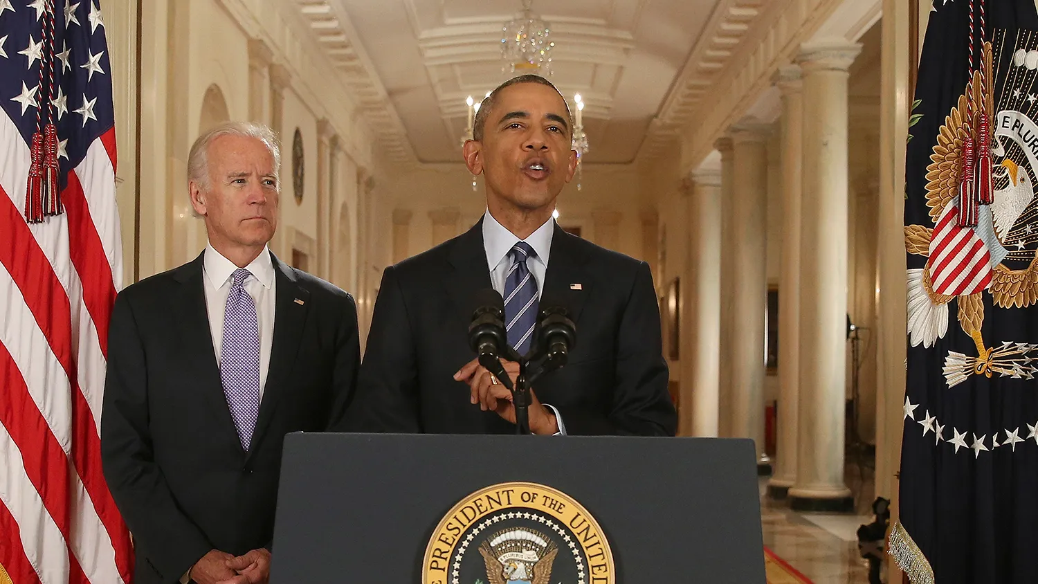 President Barack Obama, standing with Vice President Joe Biden, delivers remarks in the East Room of the White House in Washington, Tuesday, July 14, 2015, after an Iran deal is reached.
