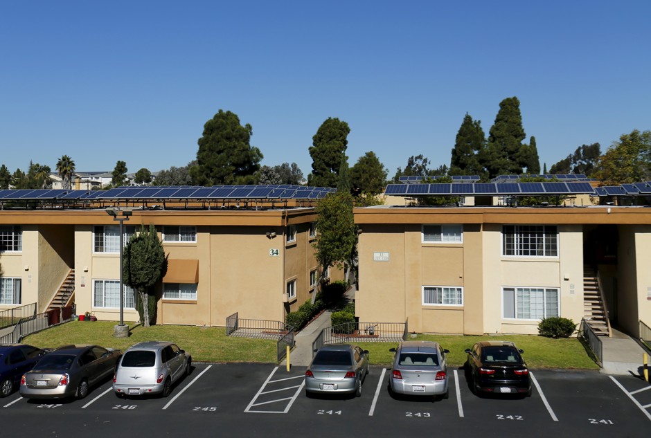 Solar panels generate energy on top of a Multifamily Affordable Solar Housing-funded housing complex in National City, California.
