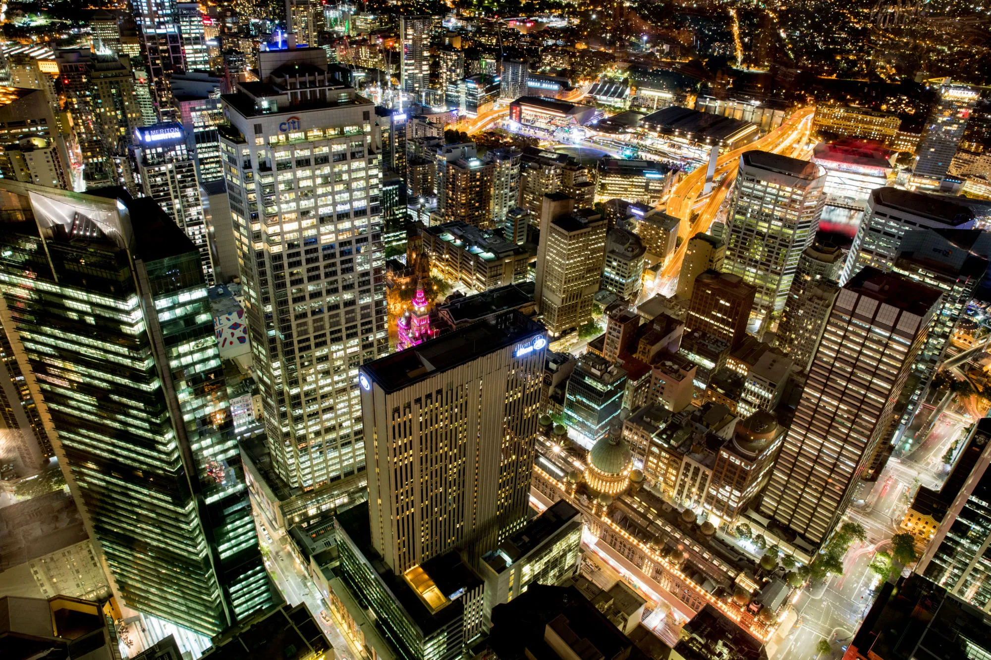 Buildings in the financial district stand illuminated at night in Sydney, Australia, on Friday, Sept. 29, 2017. A bungled transition from coal to clean energy has left resource-rich Australia with an unwanted crown: the highest power prices in the world.