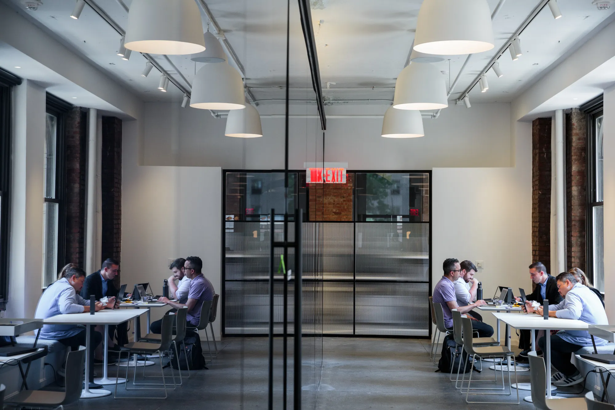 Individuals work on the fourth floor of the Convene workspace.