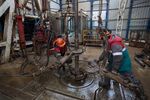 Workers fit drilling pipes on a rig at an oilfield near Almetyevsk, Tatarstan, Russia.
