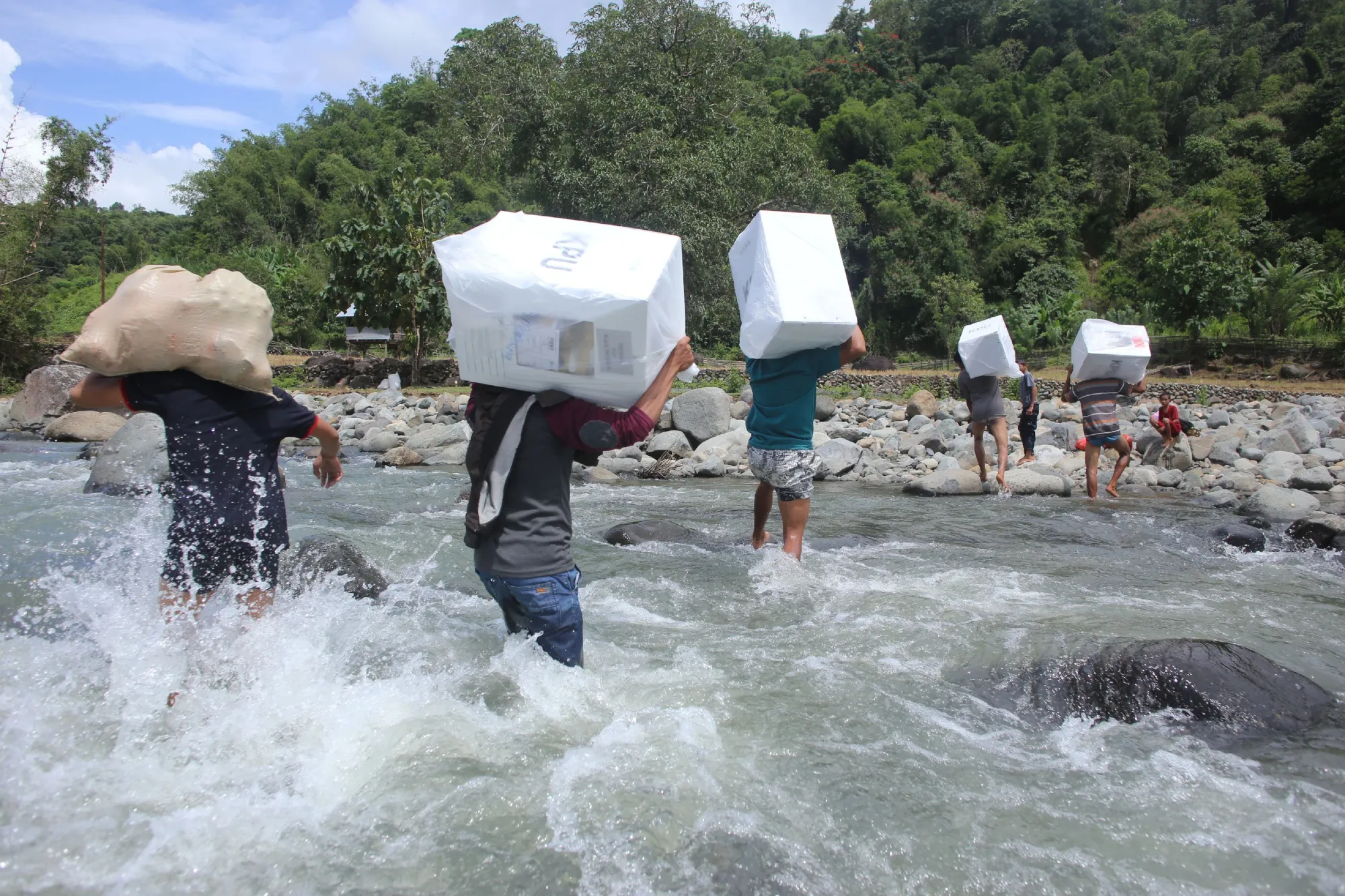 Workers transport ballot boxes for the general elections at the Bonto Matinggi village, South Sulawesi.