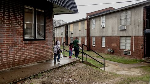 Children walk through the courtyard at the Warren Apartments.