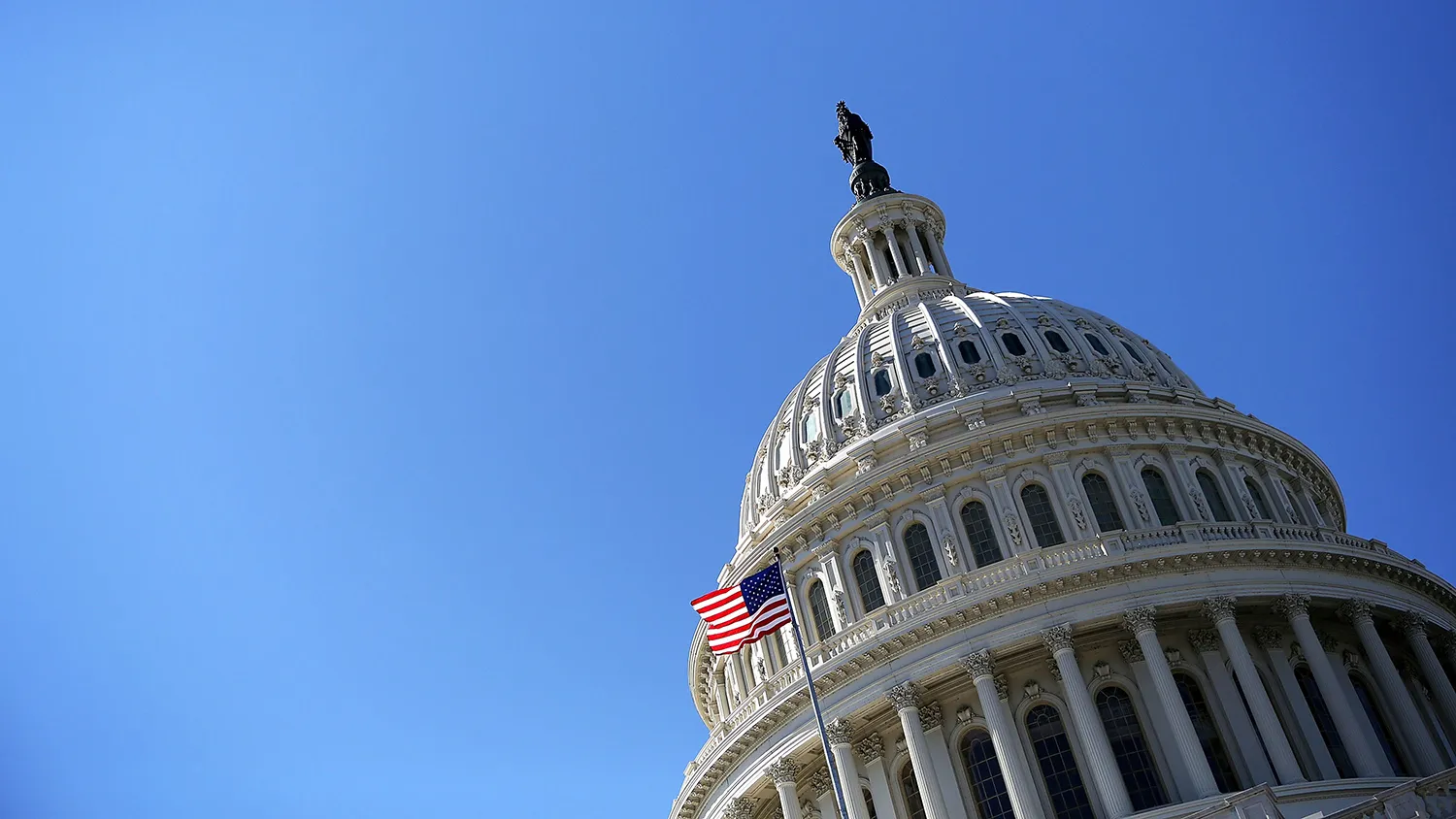 A U.S. flag flies in front of the dome of the U.S. Capitol on Feb. 12, 2013, on in Washington.
