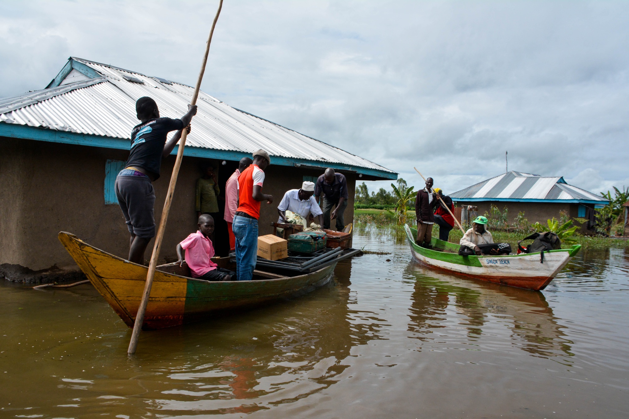 Families are evacuated after their houses were flooded in Kisumu, Kenya on Dec. 3.