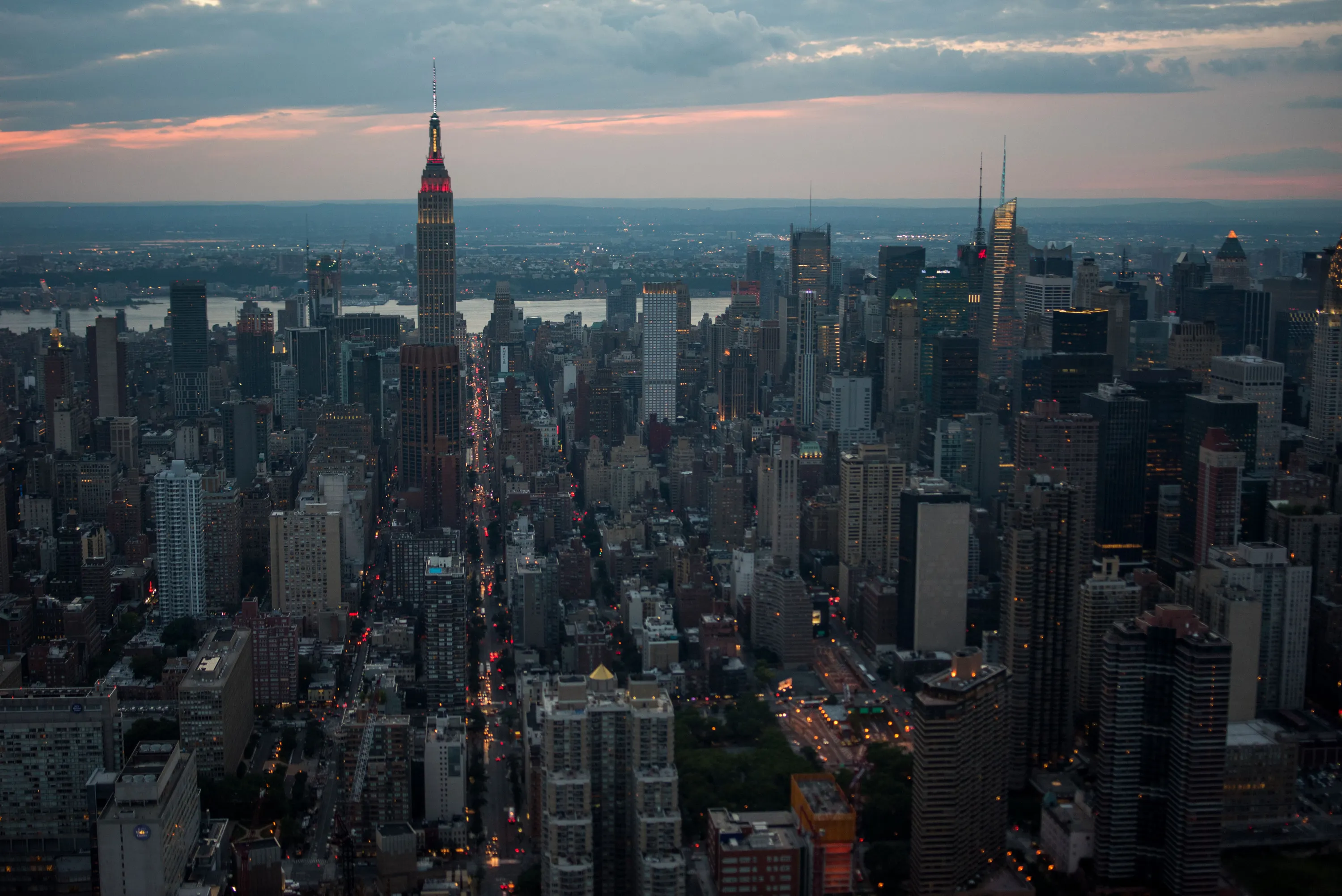 The Empire State Building stands in the Manhattan skyline at dusk in this aerial photograph taken above New York, U.S., on Friday, June 19, 2015. The Standard & Poor's 500 Index fell, with the gauge dropping below its price for the past 50 days, while Treasuries retreated.