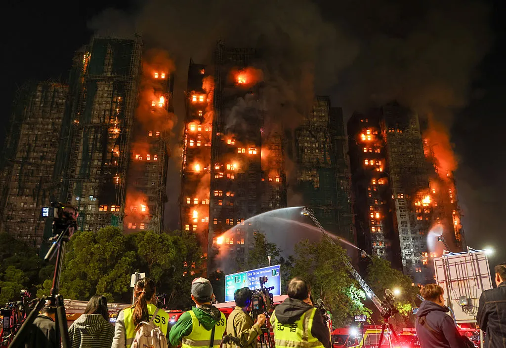 Media watch as firefighters tackle a fire engulfing residential buildings at Wang Fuk Court in the Tai Po district of Hong Kong.