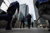 Pedestrians cross a footbridge towards the Canary Wharf business, financial and shopping district in London, U.K., on Thursday, June 5, 2018. The owners of a Canary Wharf skyscraper leased to Citigroup Inc. are seeking to refinance the 661 million-pound ($882 million) loan used to buy it five years ago, two people with knowledge of the plan said.