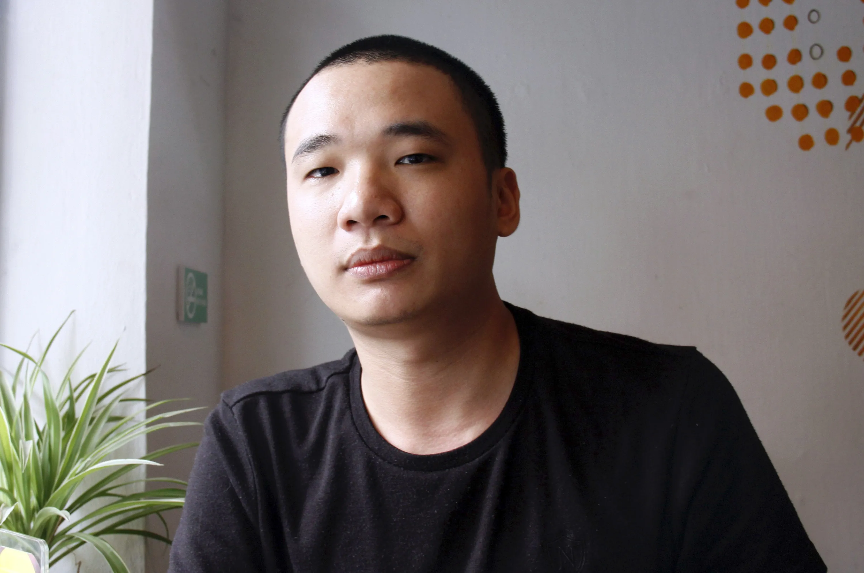 Nguyen Ha Dong, the author of the game Flappy Bird, at a coffee shop in Hanoi on Feb. 5, 2014. The Vietnamese developer behind the smash-hit free game Flappy Bird has pulled his creation from online stores after announcing that its runaway success had ruined his "simple life." Photographer: AFP via Getty Images