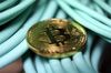 A bitcoin sits on coaxial cables inside a communications room.