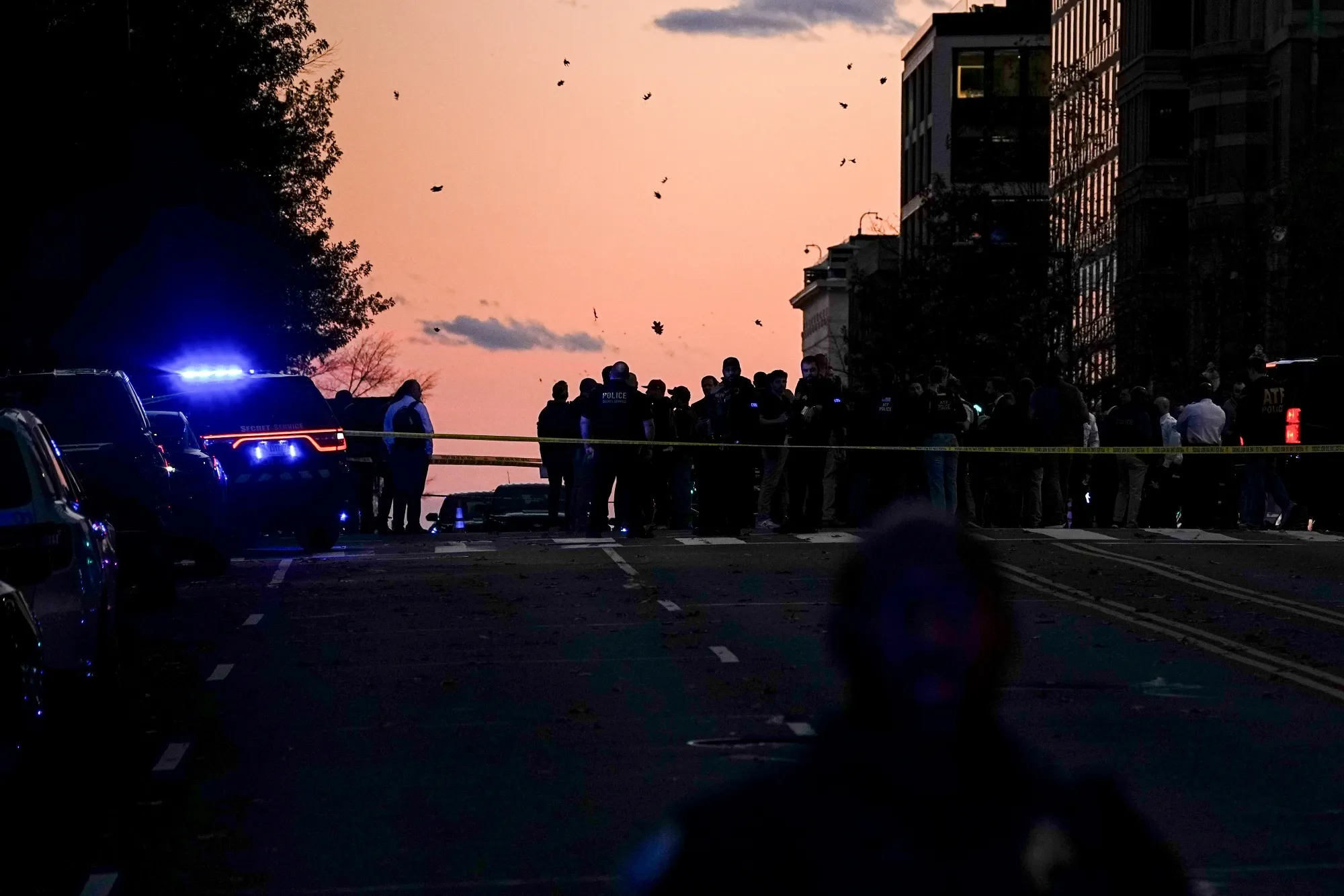 Law enforcement officers secure the scene of a shooting in Washington, DC, US, on Wednesday, Nov. 26, 2025. Two National Guardsmen were shot in downtown Washington near the White House and a suspect is in custody, officials said Wednesday.