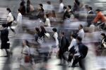 Commuters As Japan’s Wages Fall Again, Adding to Concerns Over Tax Hike
