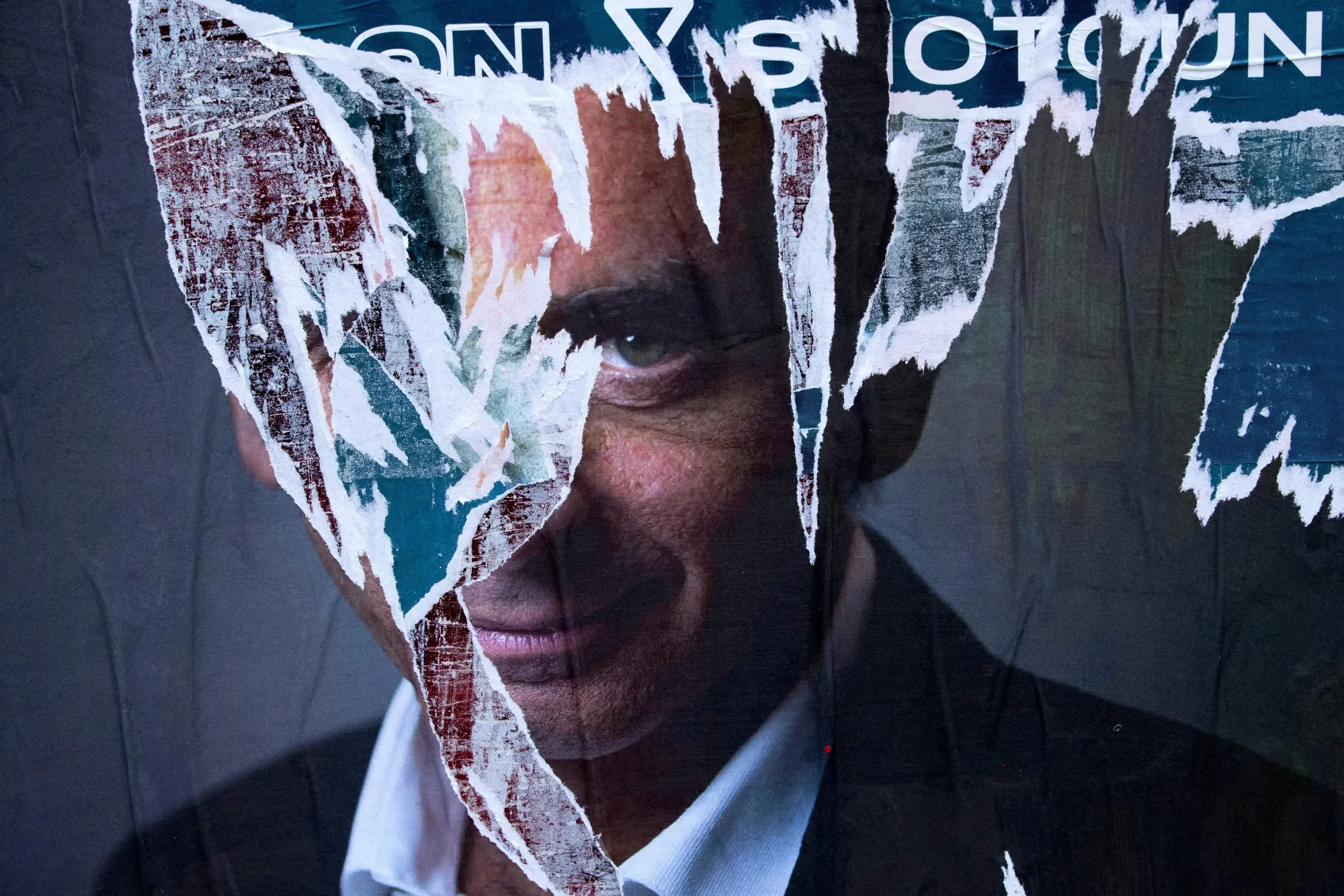 A torn poster of Eric Zemmour in Paris.&nbsp;