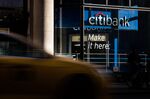 Vehicles pass in front of a Citigroup Inc. bank branch in New York, U.S.
