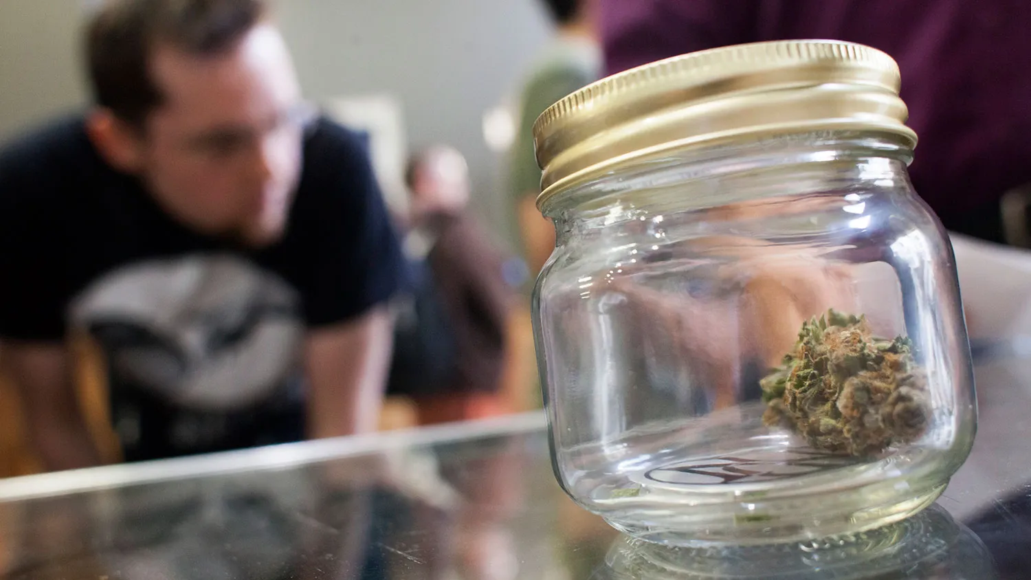 Customers shop for marijuana at Top Shelf Cannabis, a retail store, on July 8, 2014, in Bellingham, Wash.
