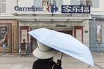 A pedestrian walks past a Carrefour SA supermarket in Shanghai, China.