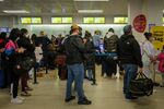 Travelers wait in line at a Spirit Airlines check-in counter at Newark Liberty International Airport (EWR) in Newark.