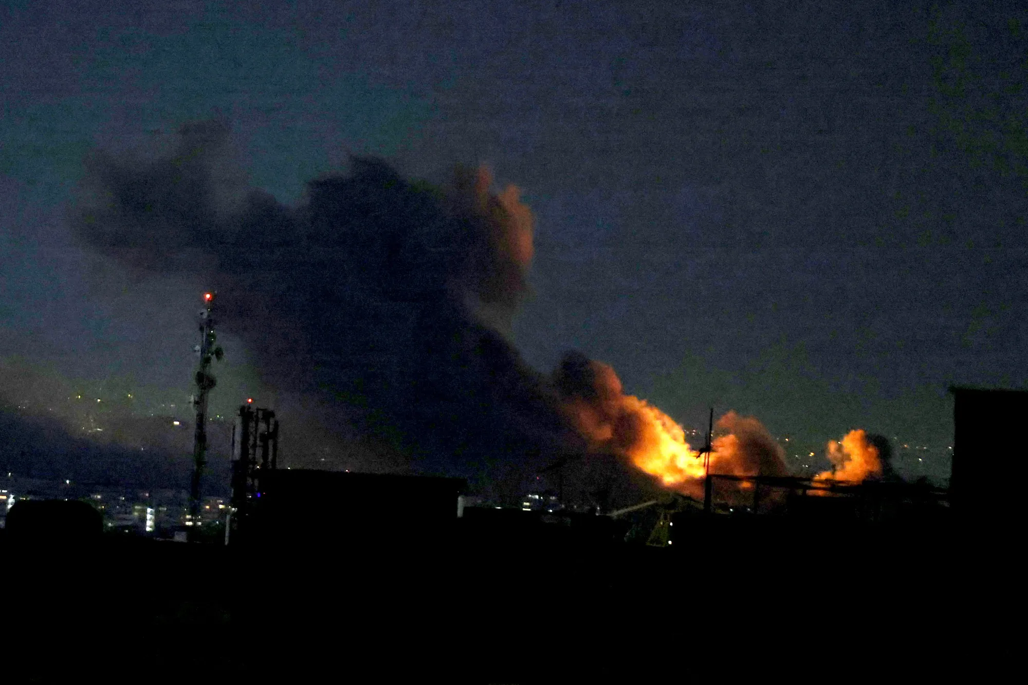 A plume of smoke rises from the site of a strike in Tehran on March 29, 2026. (Photo by ATTA KENARE / AFP via Getty Images)