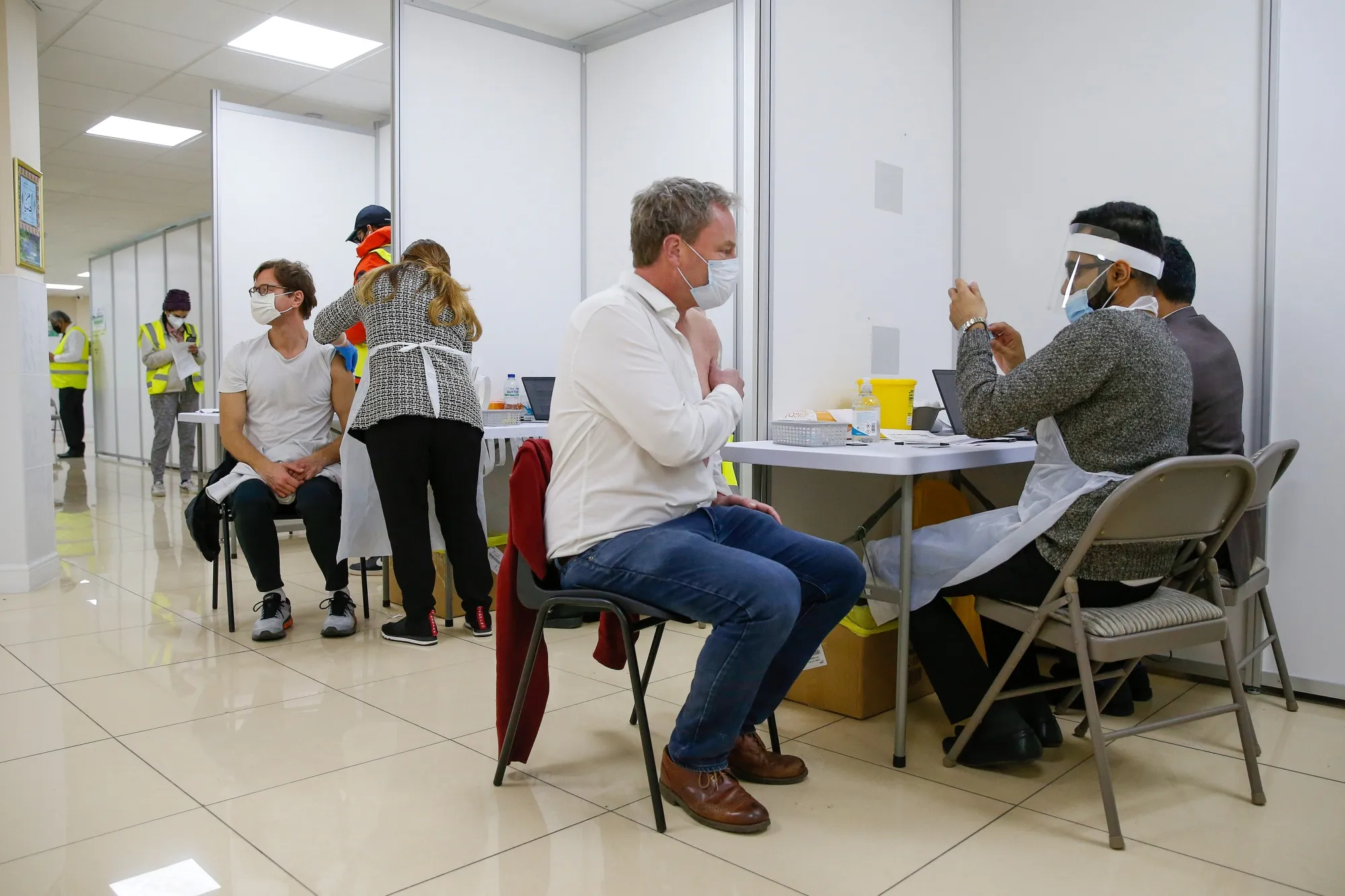 Visitors receive a dose of the Covid-19 vaccine in London.