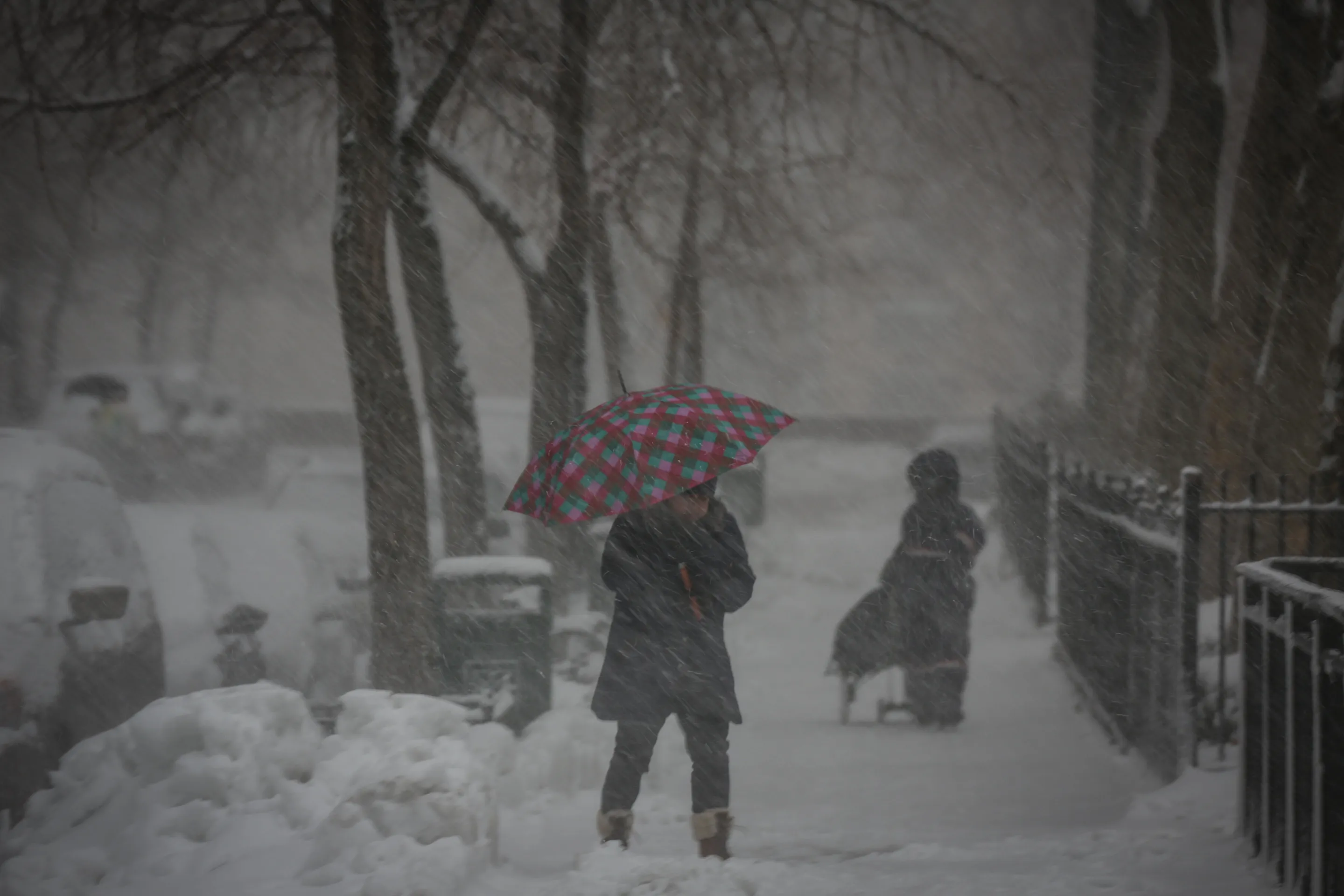 People walk during a snow storm in New York.
