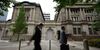 Pedestrians walk past the Bank of Japan (BOJ) headquarters in Tokyo, Japan, on Monday, July 8, 2019. Governor Haruhiko Kuroda said extremely low interest rates will be kept in place until at least around next spring while the bank will keep an eye on risks for price momentum.