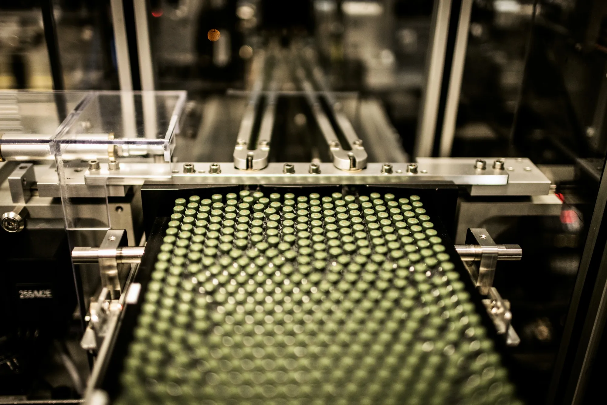 Vials move along a conveyor at the Novo Nordisk A/S production facilities in Hillerod, Denmark.