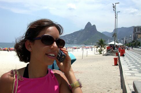 A woman uses a cellular telephone on Rio de Janeiro's Ipanema beach.