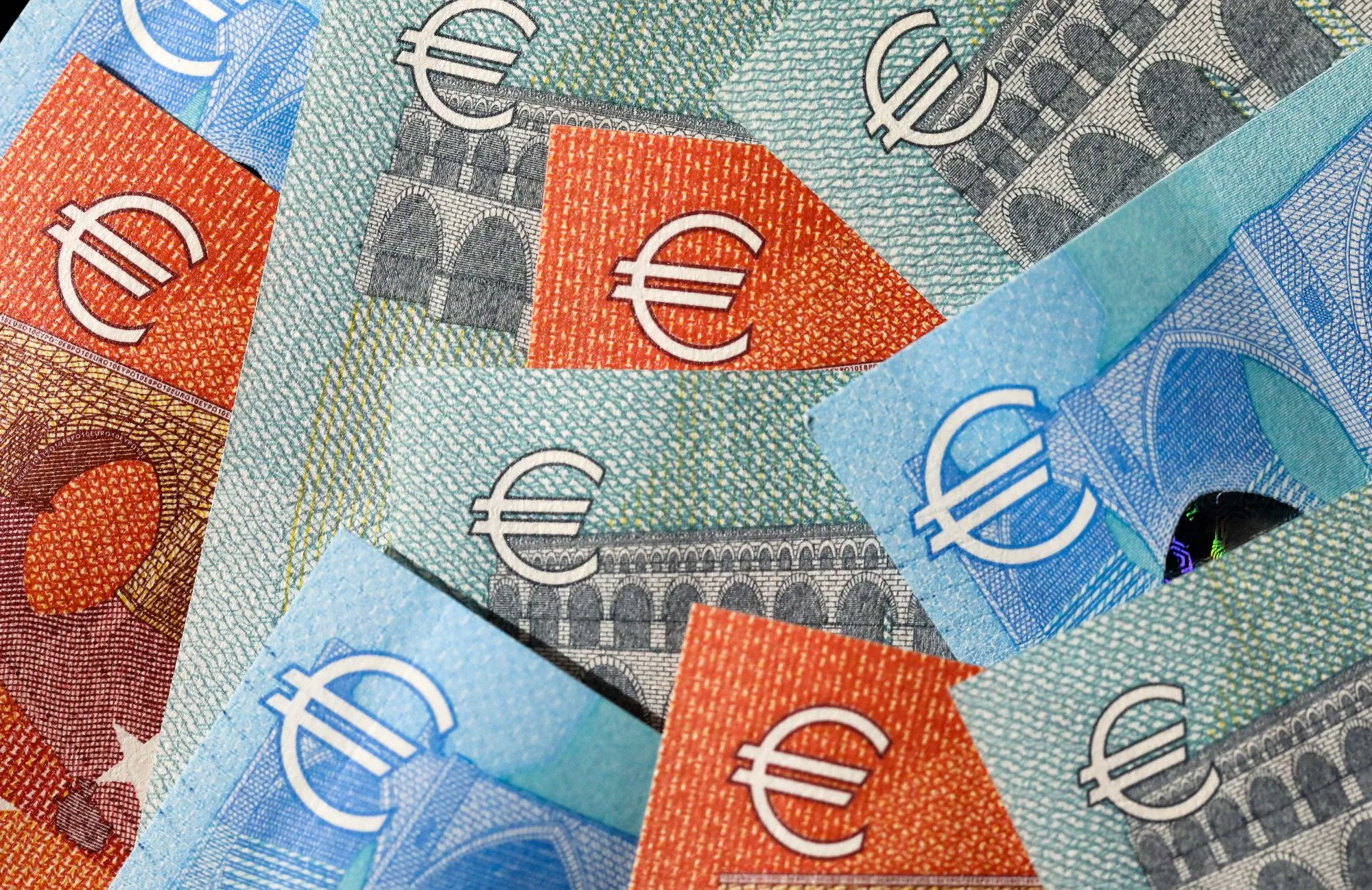 A selection of five, ten and 20 euro banknotes sit in this arranged photograph.