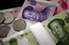 Chinese yuan banknotes and coins are arranged for a photograph in Beijing, China, on Friday, Dec. 23, 2011. China's yuan strengthened against the U.S. dollar. Indicative bid prices for the yuan were at 6.3330 per dollar as of 9:33 a.m. in Shanghai versus 6.3393 the previous trading day, according to the China Foreign Exchange Trading System.