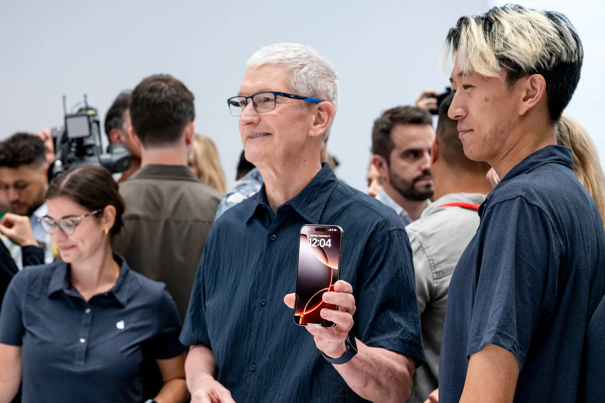 Apple’s Tim Cook holding up the iPhone 16 Pro.
