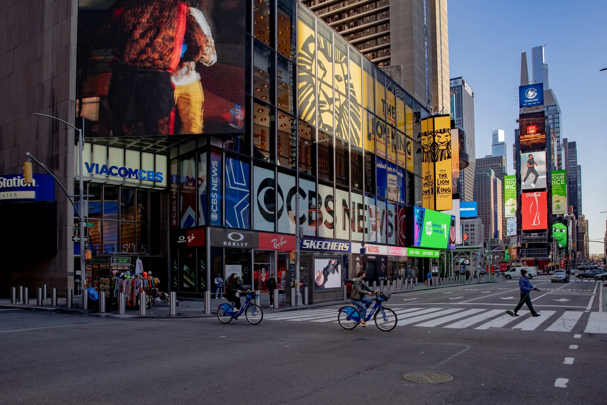 Cyclists cross a street in the Times Square neighborhood of New York.