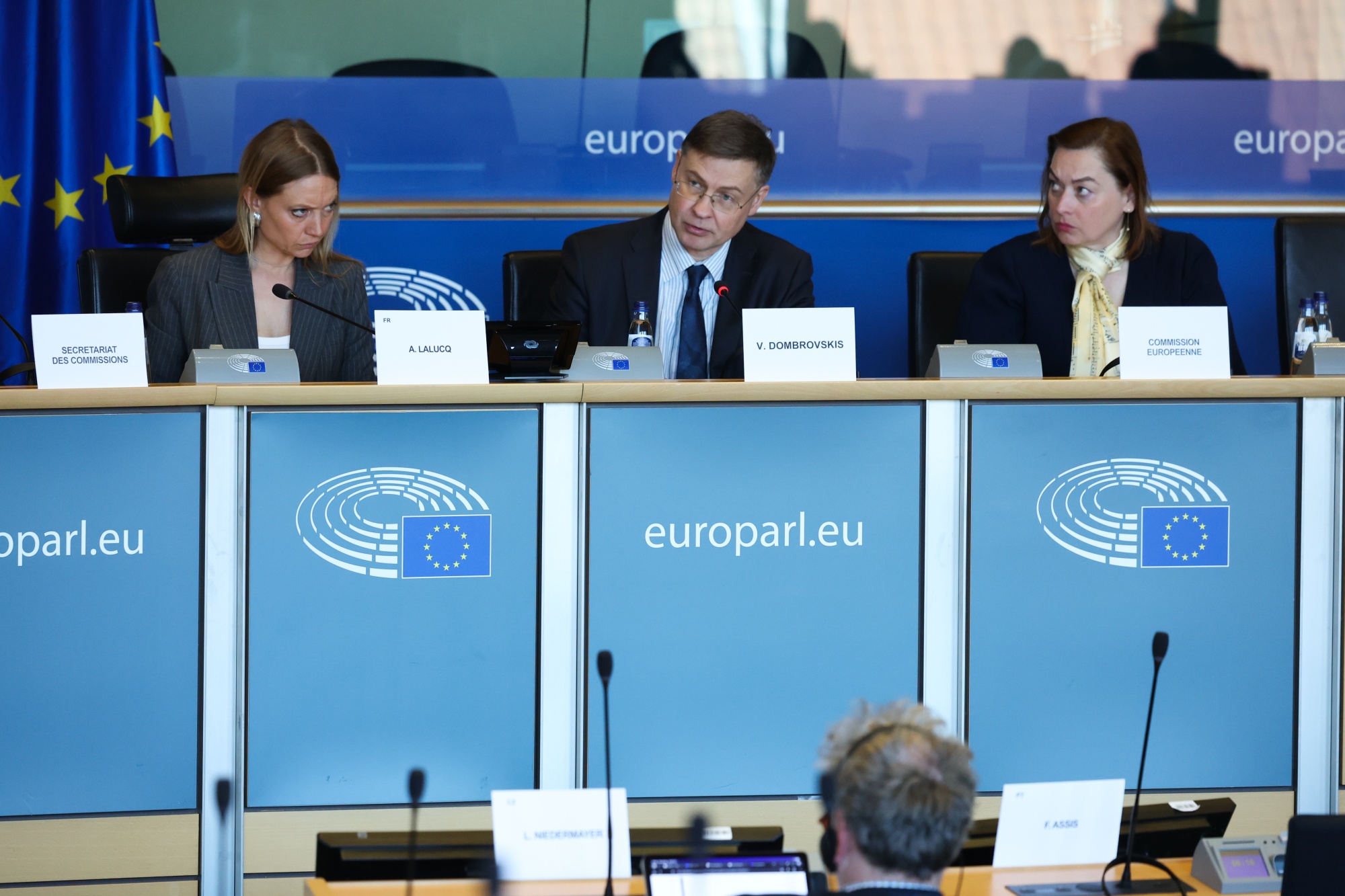 Valdis Dombrovskis, economy commissioner for the European Union (EU), center, at the European Parliament Committee meeting on Economic and Monetary Affairs in Brussels, Belgium, on Thursday, April 9, 2026. "The longer-term outlook remains clouded by profound uncertainty," Dombrovskis said. Photographer: Omar Havana/Bloomberg