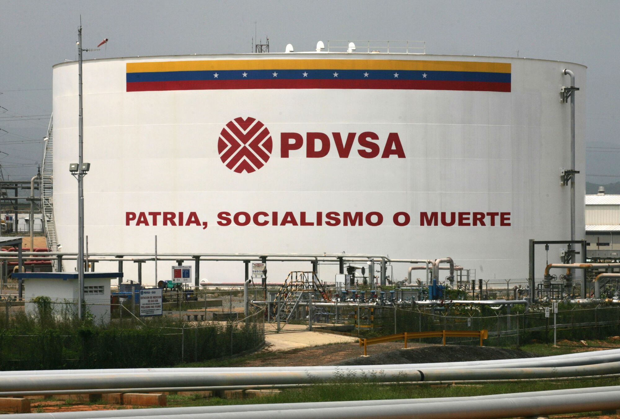 An oil tank reads "Fatherland, socialism or death" at the Jose Complex 200 miles east from Caracas.