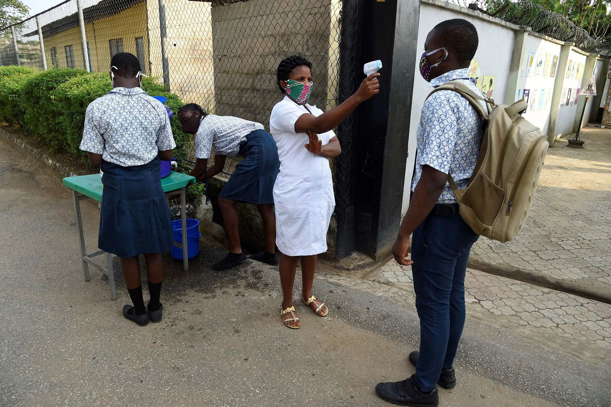 A health worker checks the temperature of students in Magboro, Ogun State, southwest Nigeria, on Aug.&nbsp;4.