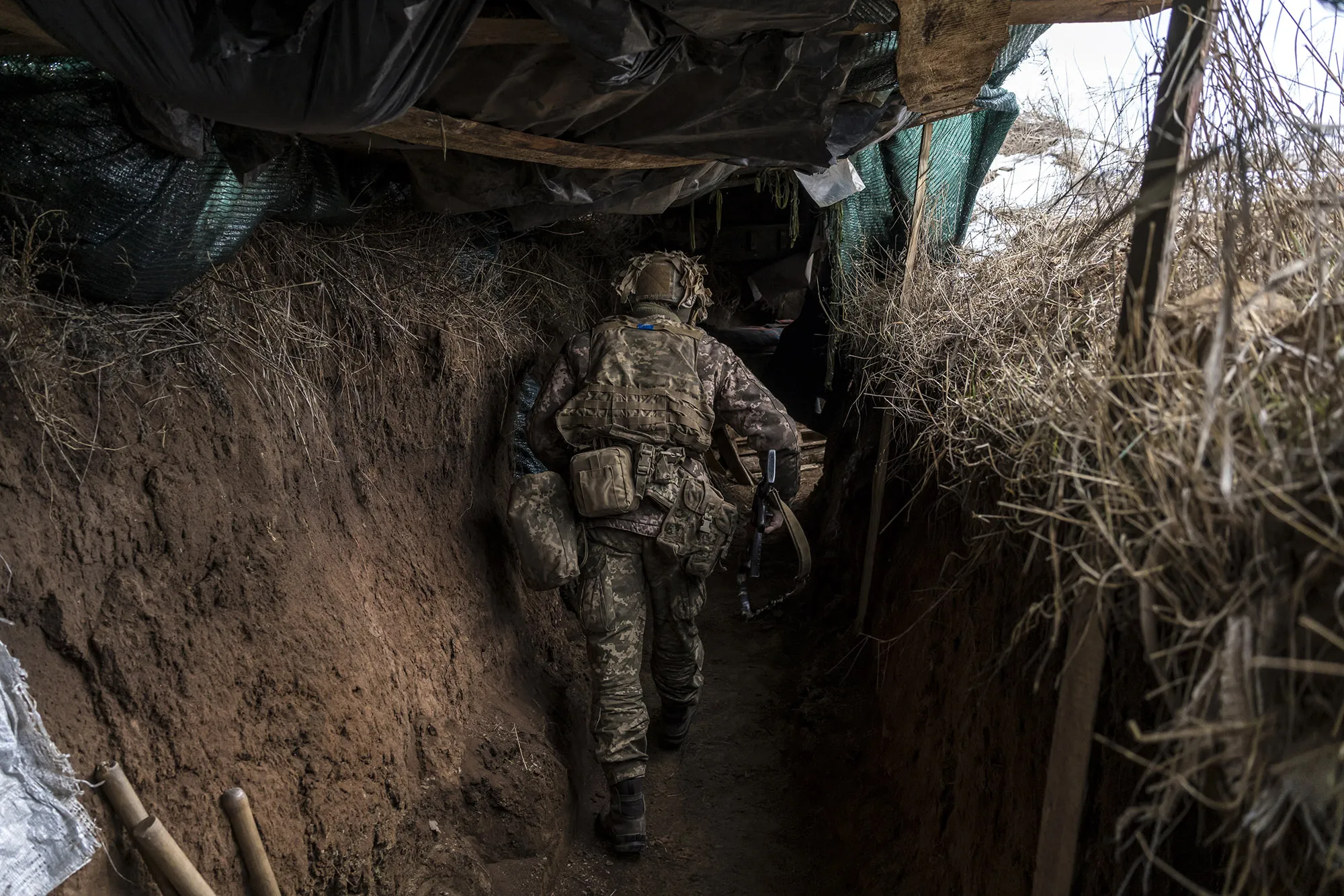 An Ukrainian soldier walks in a trench near the front line in the village of New York, formerly known as Novhorodske, Ukraine on Jan. 17.