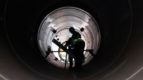 Workers inspect the inside of a large pipe in Invergordon, U.K.