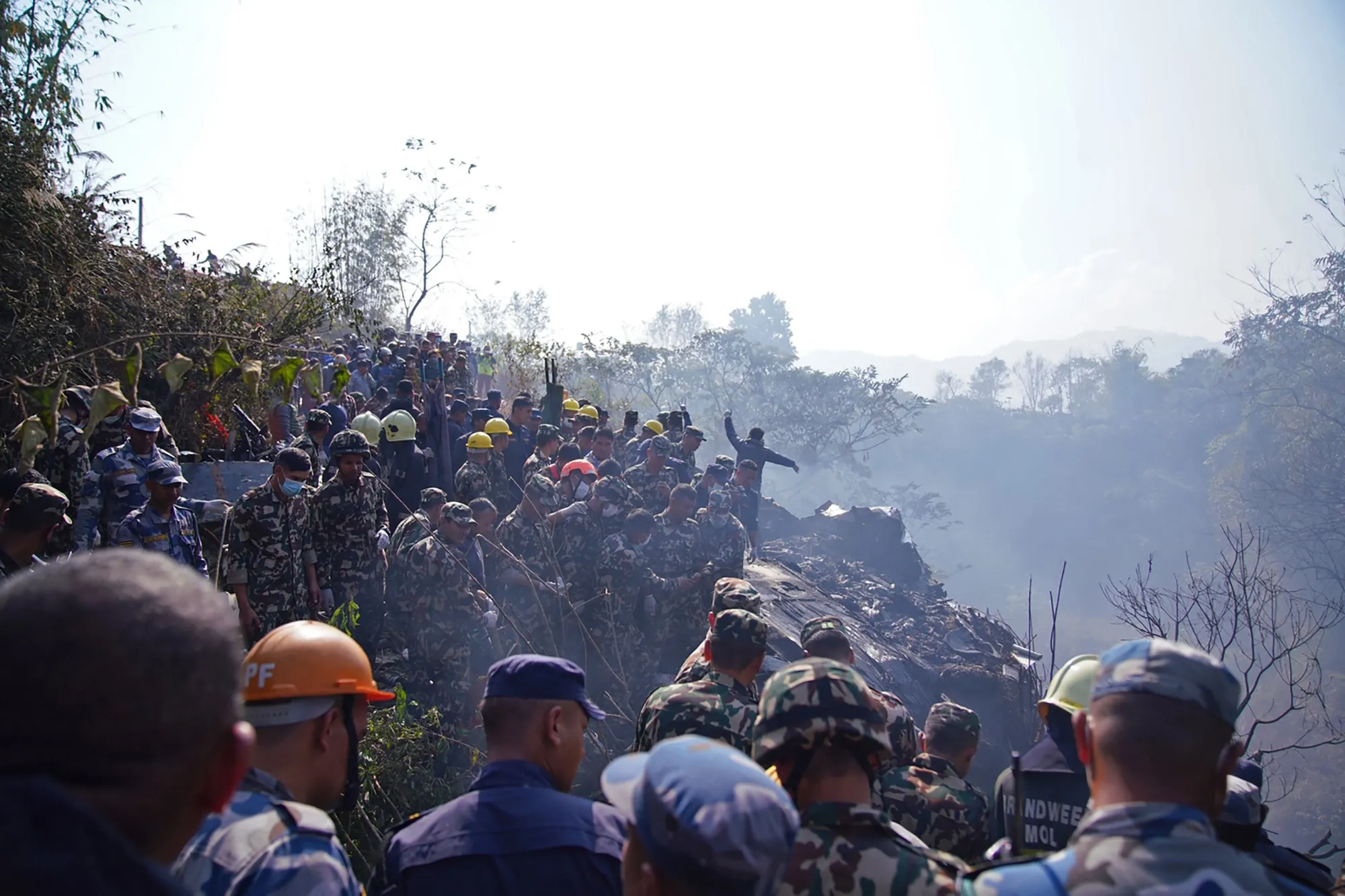 Rescuers gather at the site of a plane crash in Pokhara on Jan. 15.