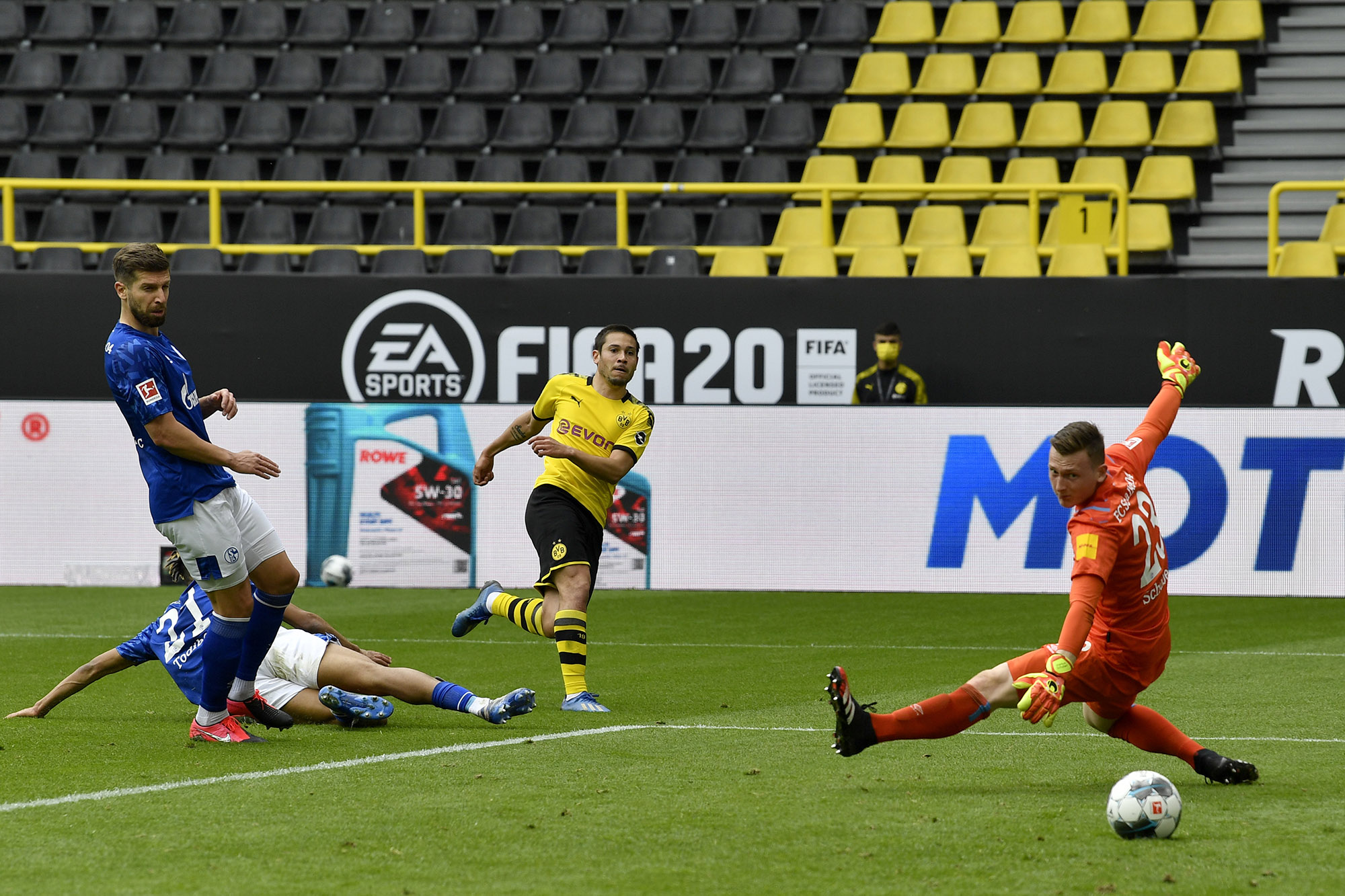 Raphael Guerreiro of Borussia Dortmund shoots and scores against Schalke,&nbsp;on May 16.