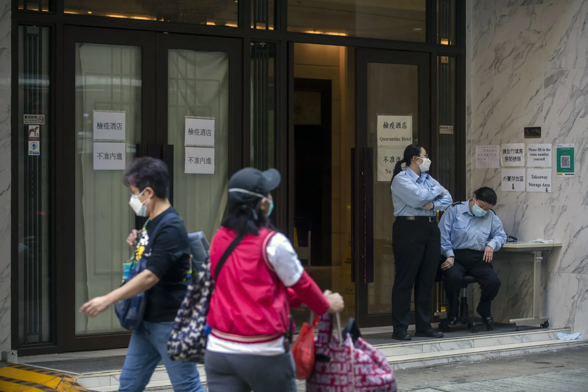 Security officers outside a quarantine hotel in Hong Kong.