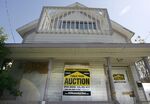 A giant foreclosure auction sign is placed in front of a home in San Jose, California in 2009.