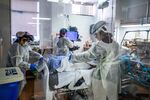 Healthcare workers attend to a Covid-19 patient at Providence Cedars-Sinai Tarzana Medical Center in Tarzana, Calif., on Dec. 18.