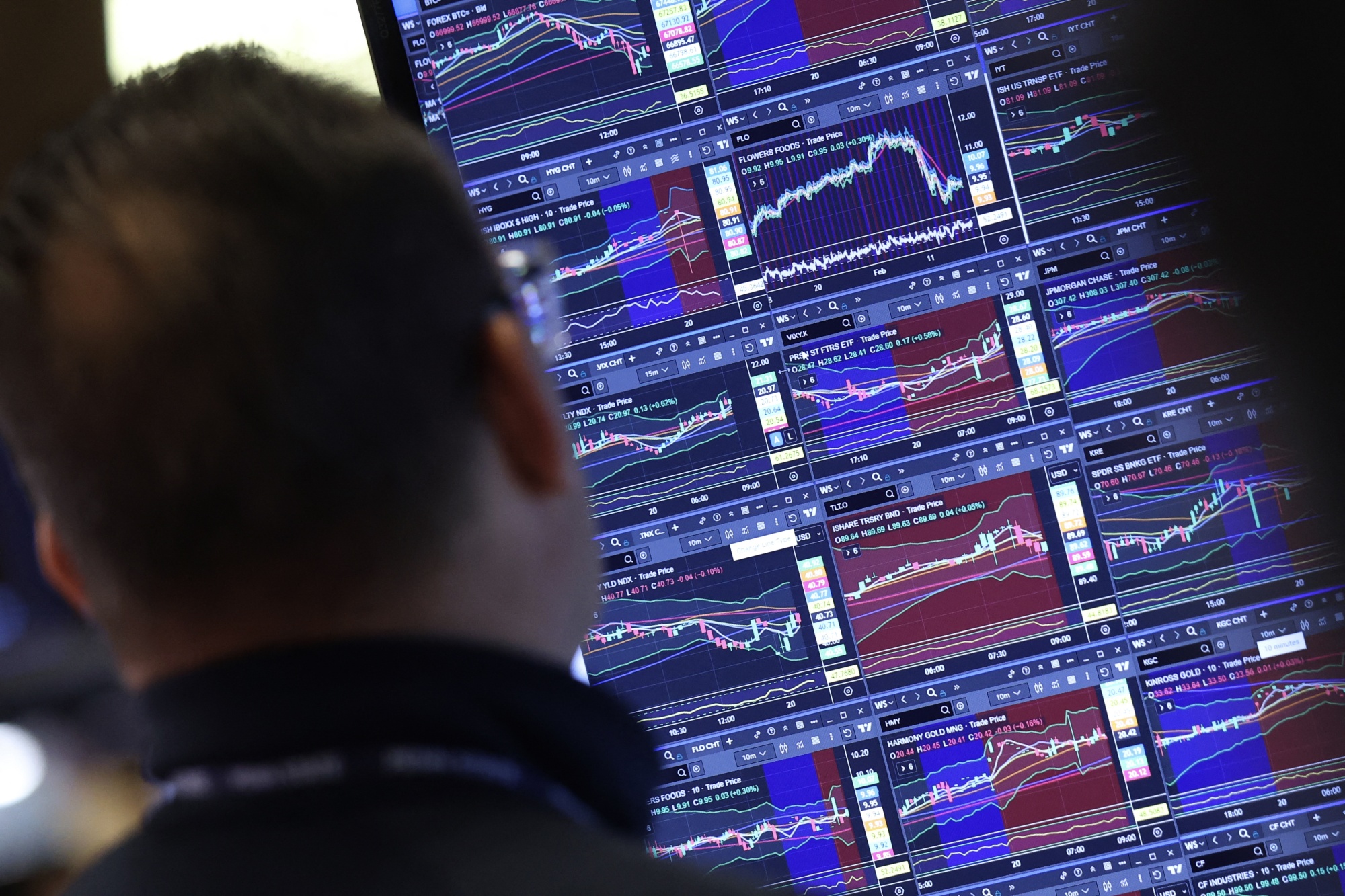 A trader works at the opening bell on the floor of the New York Stock Exchange (NYSE) in New York, on February 20, 2026. Wall Street stocks mostly fell early Friday following data showing disappointing US economic growth and an uptick in inflation. (Photo by TIMOTHY A. CLARY / AFP via Getty Images)
