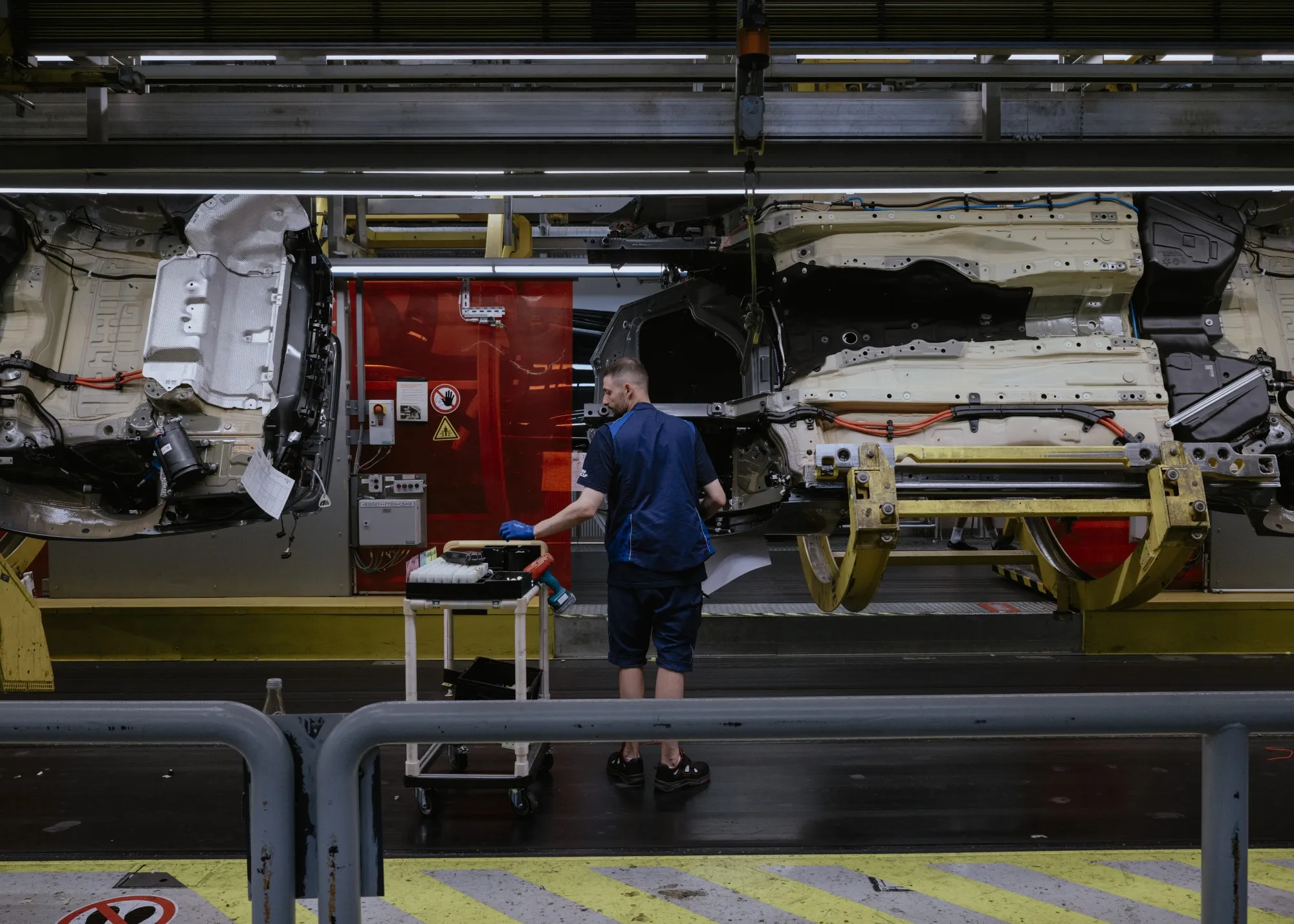 Vehicles move along an assembly line at a&nbsp;manufacturing facility in Munich.