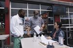 A job seeker, left, talks to staff members during a restaurant and hospitality career fair in Torrance, California, on June 23.