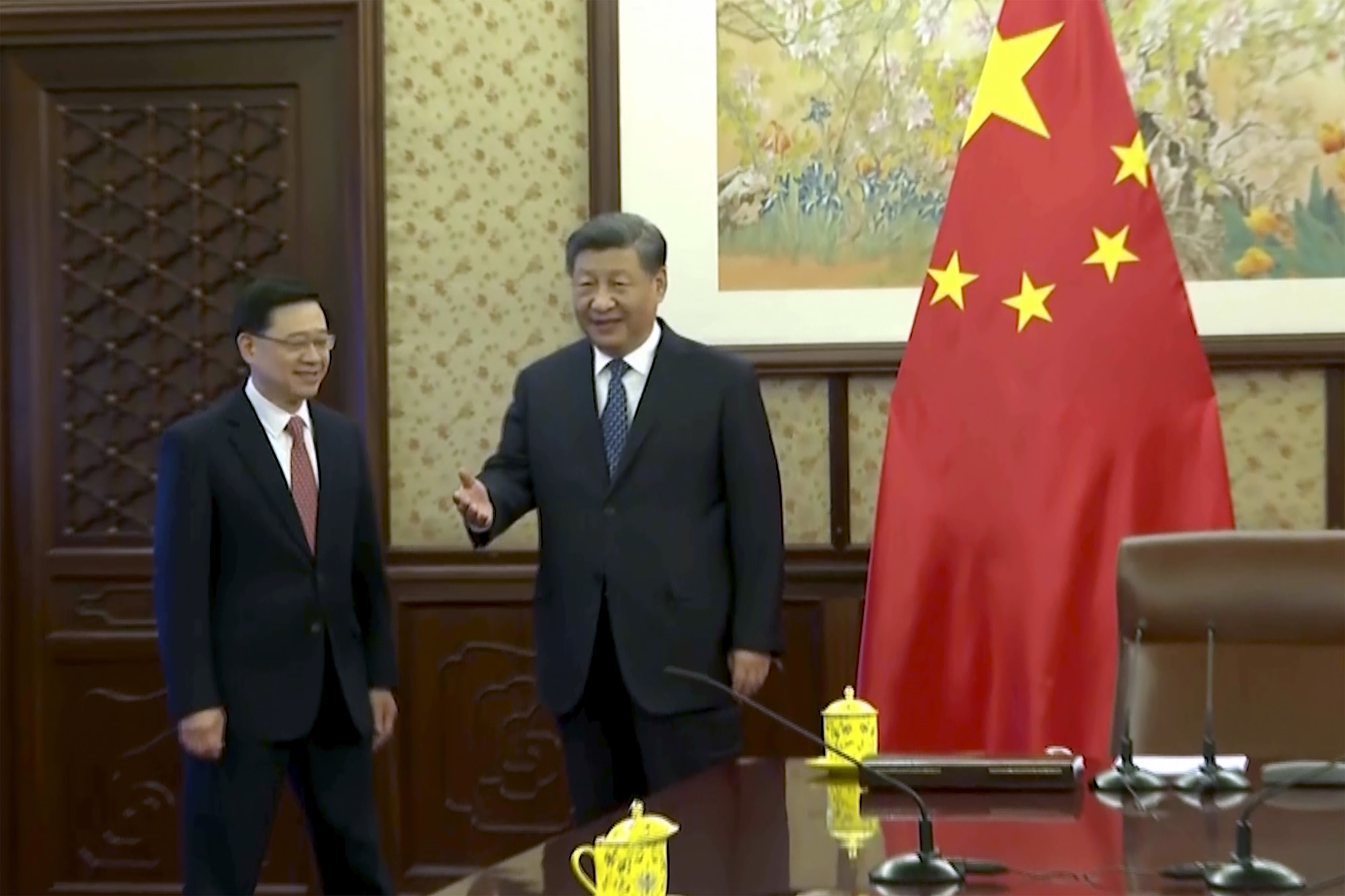 Xi Jinping, right, as he meets John Lee in Beijing, Dec. 23.