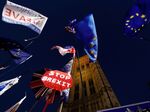 Banners, Union and EU flags are displayed outside the Houses of Parliament in London on October 22, 2019.