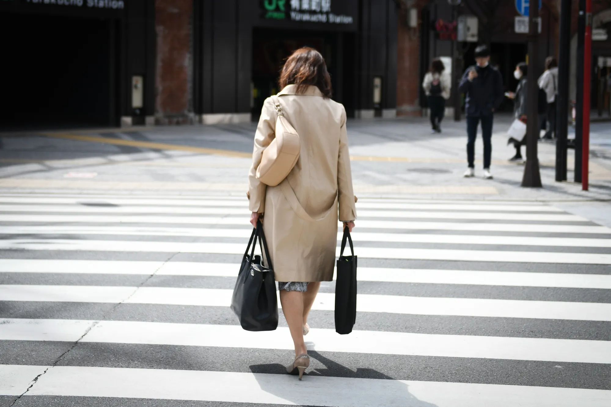 A pedestrian crosses a street&nbsp;in Tokyo.