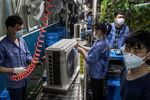 Employees working on an air conditioner production line at a Midea factory in Wuhan, China on March 25.