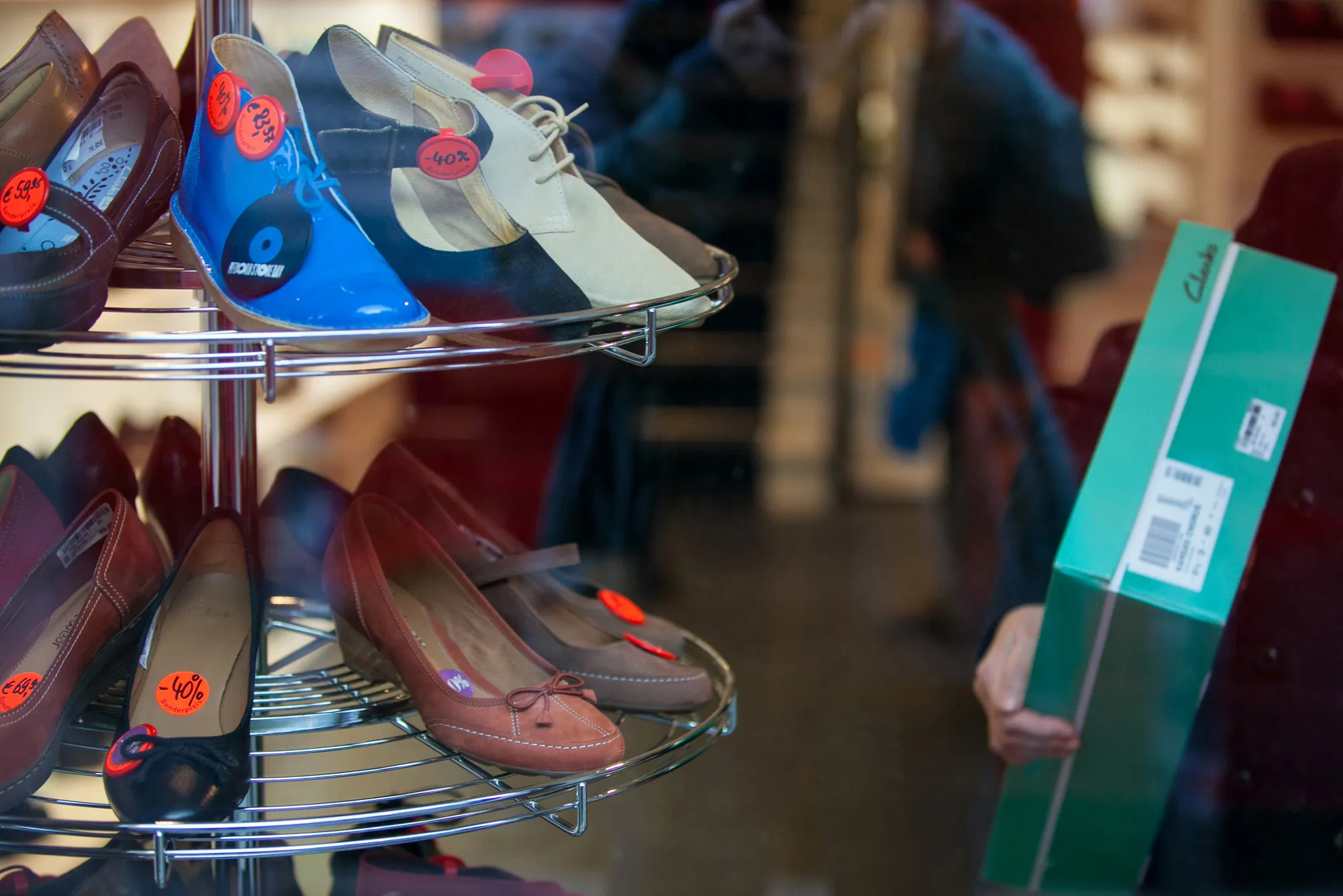 Footwear sits on display at discounted sale prices inside a Clarks footwear store, operated by C. and J. Clark International Ltd, in Berlin, Germany.