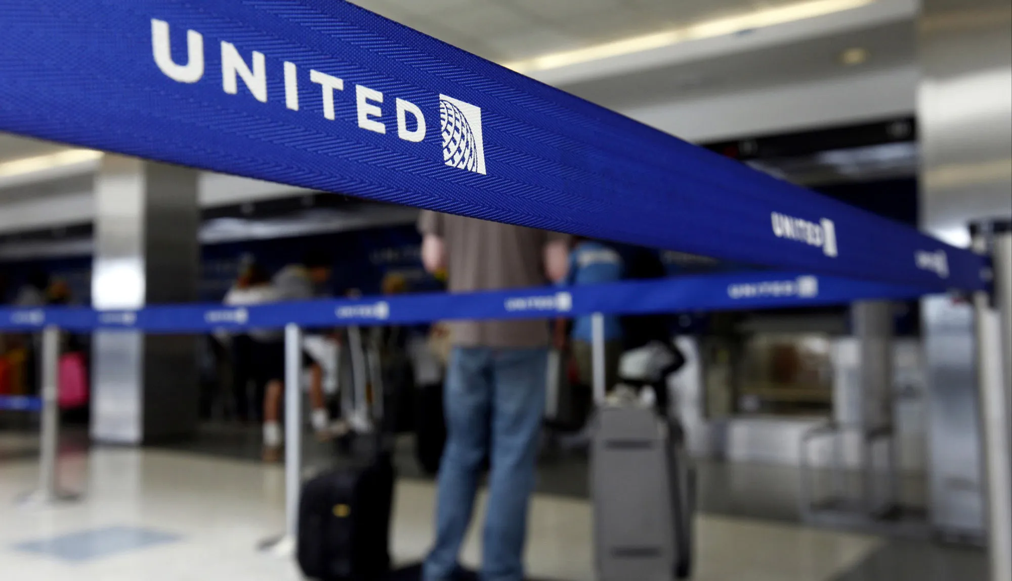Travelers check in for a flight at a United Continental&nbsp;ticket counter at Los Angeles International Airport.
